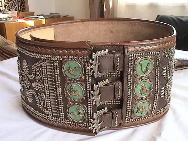 A traditional Hutsul cheres belt with brass studs and green enamel medallions